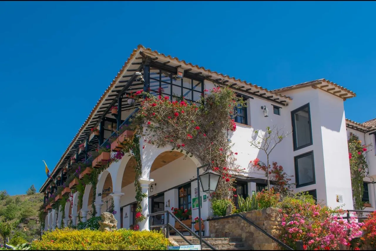 Fachada de la Hospedería Duruelo, con sus arcos y balcones cubiertos de buganvilias